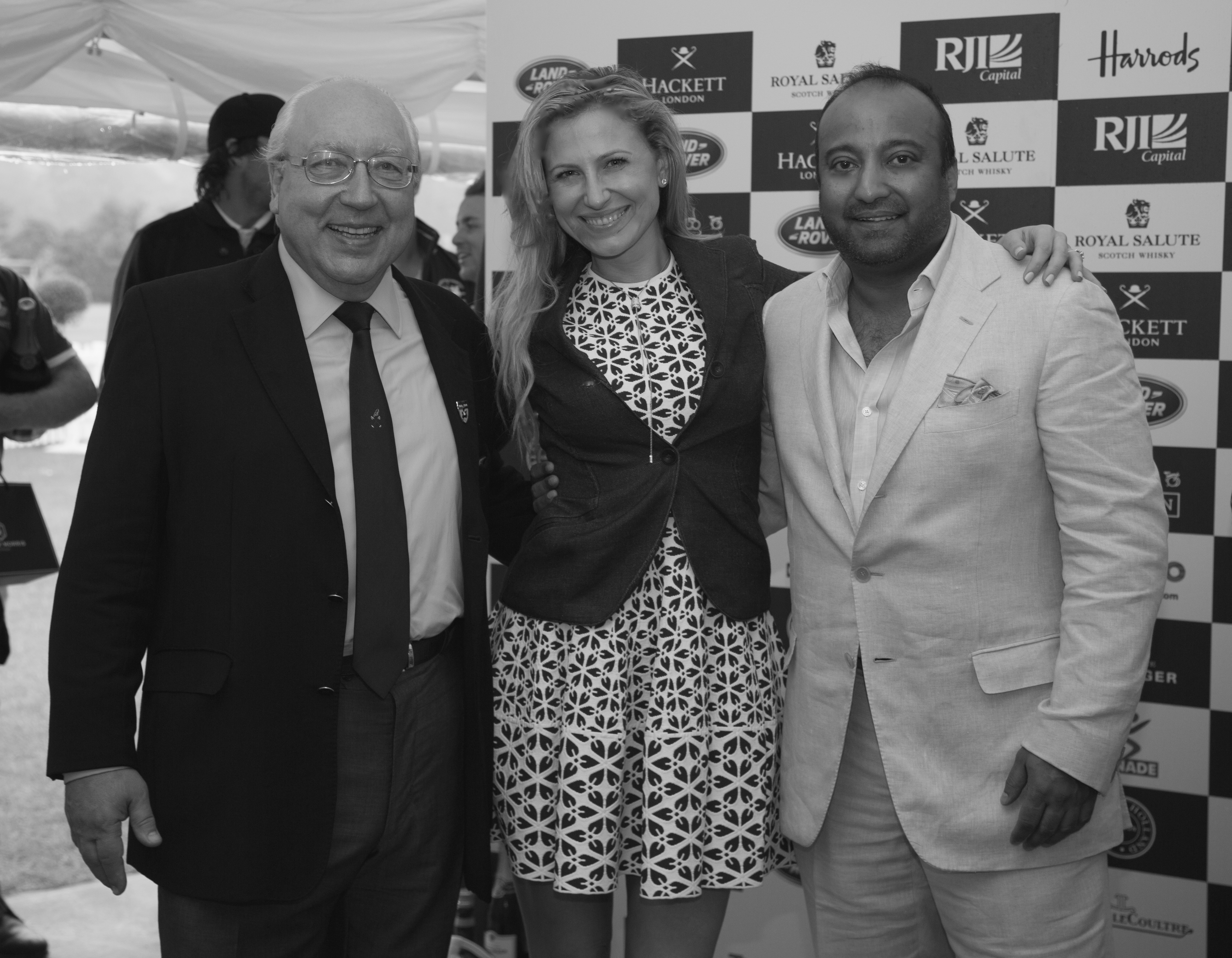Ron Wahid, CEO of RJI Capital and his fiancée, art consultant Magdalena Kruszewska pose with Urs Schwarzenbach, who hosted British Polo Day at his estate in Henley-on-Thames on June 20.